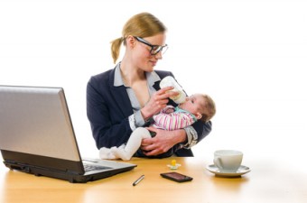 businesswoman gives baby the bottle