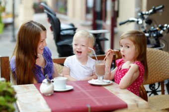 Mother and her daughters relaxing in outdoor restaurant