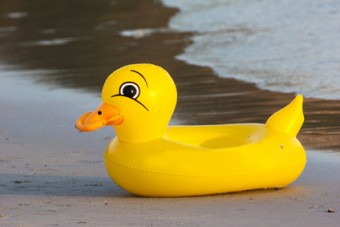 duck rubber ring, duck swim-ring on the beach